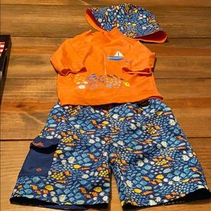 matching swim set with trunks, rash guard, hat